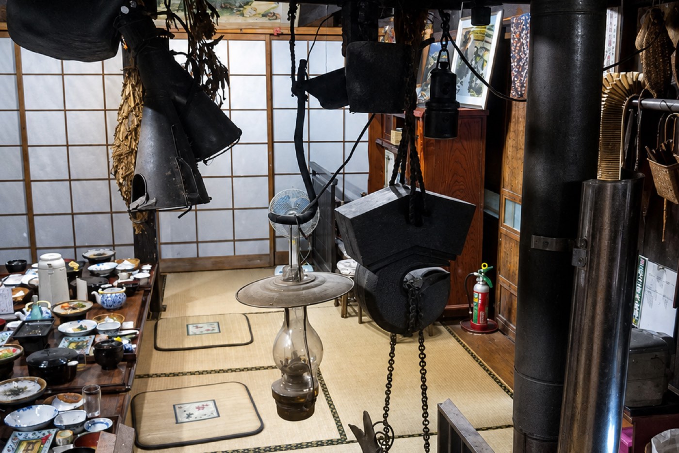 A low table set for several guests in a minshuku, floor seating on tatami.