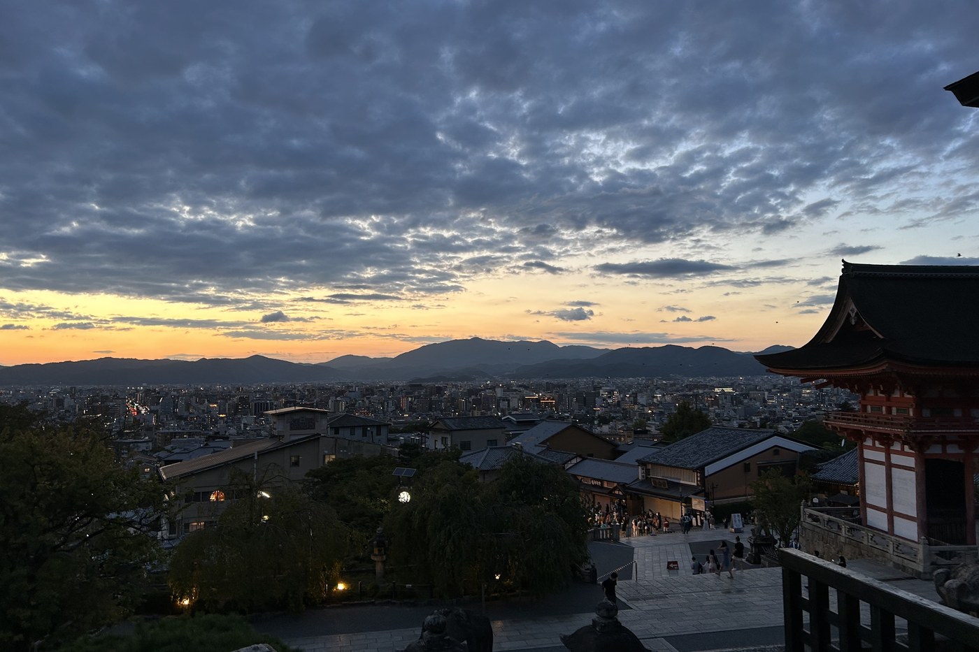 Kyoto at sunset seen from Kiyomizu-dera temple, mountains behind.