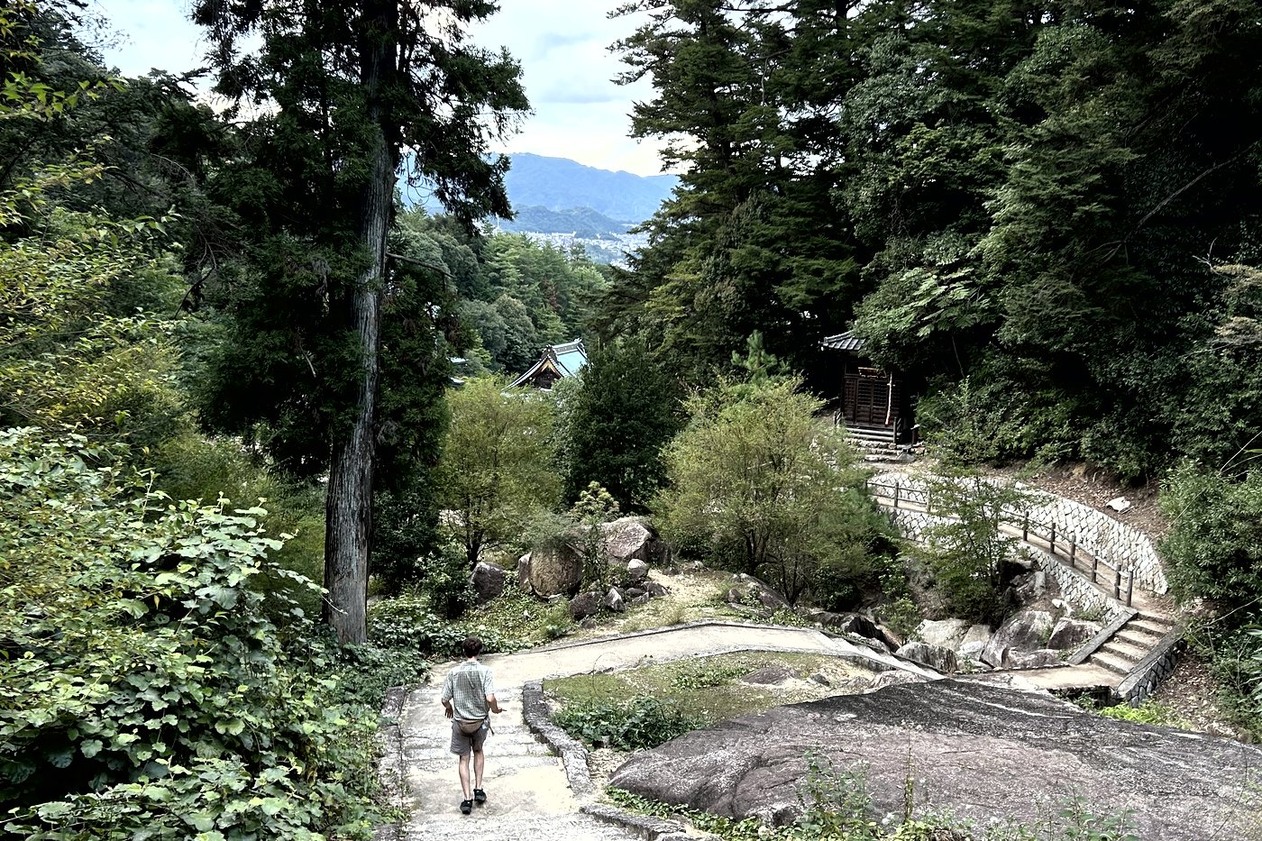 A stone path leading to a small shrine in the forest of Mount Misen, on Miyajima.